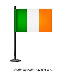 Realistic Irish table flag on a black steel pole. Souvenir from Ireland. Desk flag made of paper or fabric and shiny metal stand. Mockup for promotion and advertising. Vector illustration