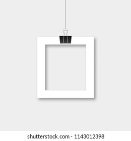 Realistic isolated paper photo frame hanging by binder clips. Retro vintage style mockup. Vector illustration. Easy to edit template with blank area for your picture.
