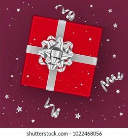 A realistic red gift box decorated with a silver bow, top view. Vector illustration