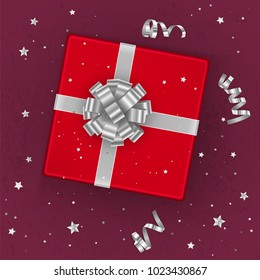 A realistic red gift box decorated with a silver bow, top view. Vector illustration