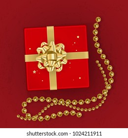 A realistic red gift box decorated with a gold bow, top view. Vector illustration