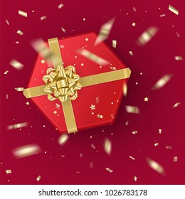 A realistic red gift box decorated with a gold bow, top view. Vector illustration