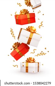 Realistic red and white gift boxes. Falling shiny golden confetti isolated on white background. Bright festive tinsel of gold color. Xmas present