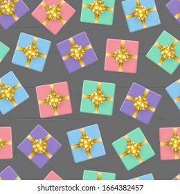 Realistic seamless pattern. Gift multi-colored boxes tied with a gold ribbon and a bow in the form of a flower. Against the background of gray wooden boards. Decoration of any holiday.