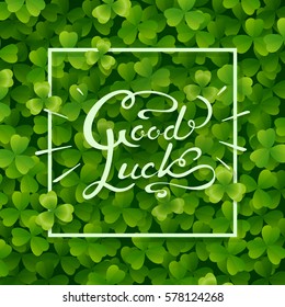 Realistic shamrock leaves background. Green irish symbol Good Luck. Vector clover pattern with hand drawn lettering for Saint Patrick's Day holiday greeting card design
