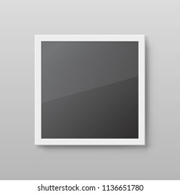 Realistic square picture frame isolated on grey wall. Mockup photo frame with white border and black empty place. Blank vector template with shadow effect for artwork exhibition or interior decoration