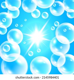 Realistic transparent bubbles in blue water. Soap bubbles flying towards the sun. Vector illustration on a blue background.