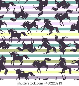 Realistic unicorn silhouette seamless pattern on a striped background