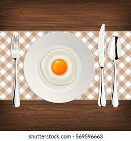 Realistic vector fried egg icon on a plate with fork and knife. Design template.
