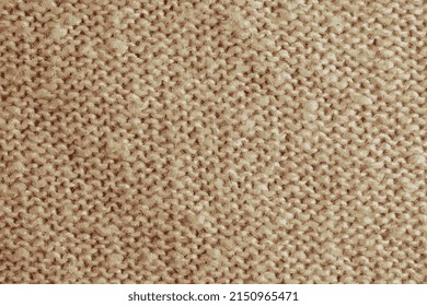 Realistic vector illustration of a beige knitted carpet close-up. Textile texture on a beige background. Detailed warm yarn background. Natural wool fabric, sweater fragment.
