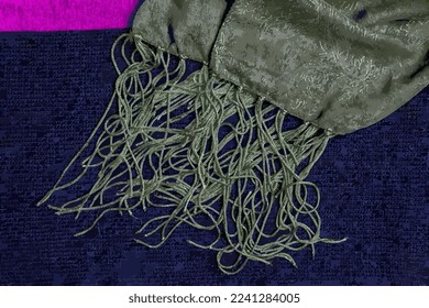 Realistic vector illustration of a green silk shawl with a fringe along the edge of the fabric against a dark blue woolen fabric background. Abstract background.
