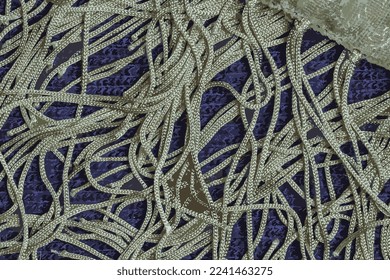 Realistic vector illustration of a green silk shawl with a fringe along the edge of the fabric against a dark blue woolen fabric background. Abstract background.
