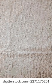 Realistic vector illustration of the texture of a light beige bath towel with a large volume
