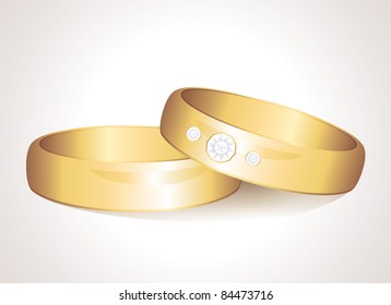 realistic wedding gold rings on white background