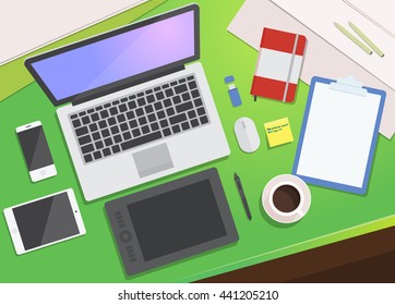 Realistic workplace organization. Flat Lay. View from above: desktop, laptop, smartphone, tablet, graphics tablet, diary, pencil, coffee mug, flash card.