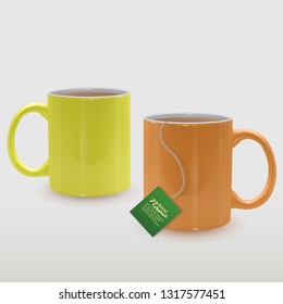 Realistic yellow and orange tea cups, tea mugs on white background.