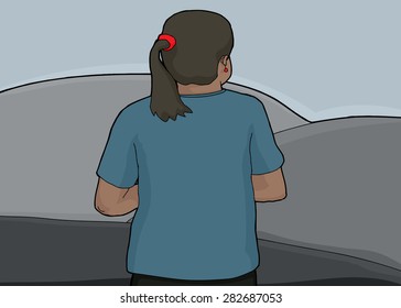Rear view of Hispanic female looking over gray hills