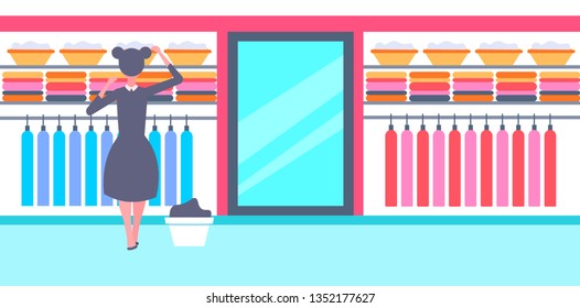 rear view maid in black and white uniform organizing clean clothes housewife in family clothing wardrobe effective house organization concept horizontal full length