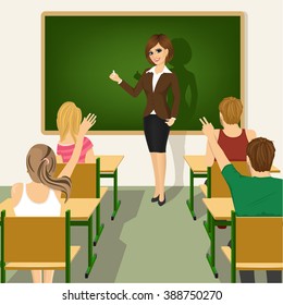 rear view of school lesson with students and teacher in classroom with green chalkboard and desks