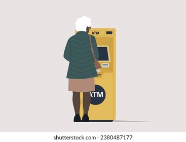 A rear view of a senior lady withdrawing money from an outdoor ATM machine