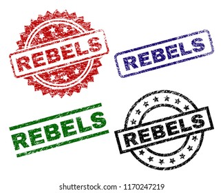 REBELS seal prints with distress surface. Black, green,red,blue vector rubber prints of REBELS text with unclean style. Rubber seals with circle, rectangle, rosette shapes.