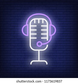Recording studio neon icon. Mic and headset on brick wall background. Sound equipment concept. Vector illustration can be used for neon signs, billboards, show business