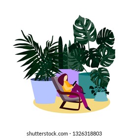 In the recreation area, surrounded by huge flowers, the girl sits comfortably in a rocking chair and holds a gadget in her hands