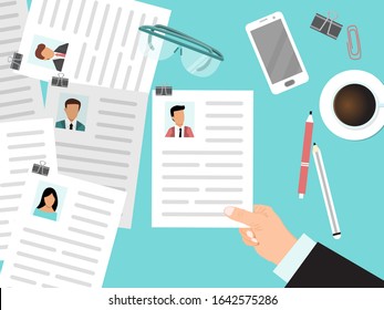 Recruitment with cv view from the top concept. HR manager looks through resumes of employees. Business man looking for company employee by curriculum vitae. Hand with cv on the top of desk.
