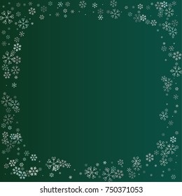 Rectangle Christmas frame or border with random scatter falling silver snowflakes isolated on a dark green gradient background