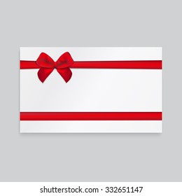 Rectangle paper card with red ribbon and tied bow.