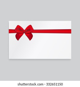 Rectangle paper card with red ribbon and tied bow.