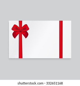 Rectangle paper card with red ribbon and tied bow.