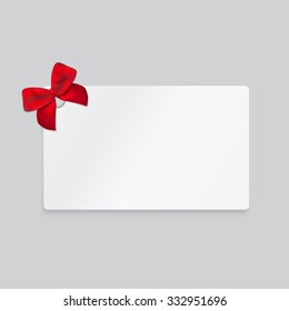 Rectangle white paper card with red tied bow.