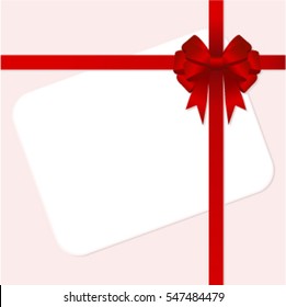 Rectangle white paper card with red ribbon and tied bow.
