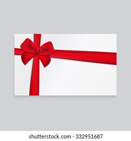Rectangle white paper card with thick red ribbon and tied bow.
