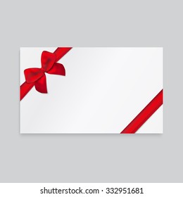 Rectangle white paper card with thin red ribbon and tied bow.