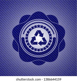 recycle icon inside badge with denim background