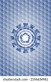 recycle icon inside blue badge with geometric pattern. 
