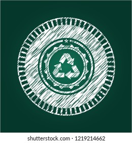 recycle icon inside chalk emblem written on a blackboard