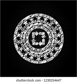 recycle icon inside chalk emblem written on a blackboard