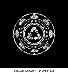 recycle icon inside chalk emblem written on a blackboard