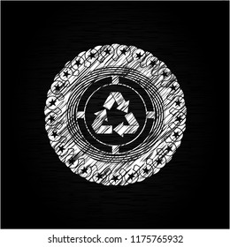 recycle icon inside chalkboard emblem written on a blackboard