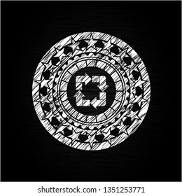 recycle icon inside chalkboard emblem on black board