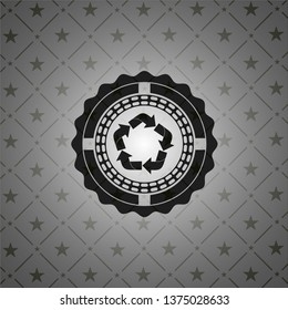 recycle icon inside dark badge or emblem