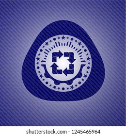 recycle icon inside emblem with jean background