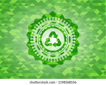 recycle icon inside green emblem with triangle mosaic background