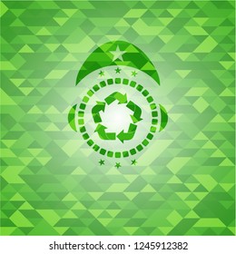 recycle icon inside green emblem with triangle mosaic background