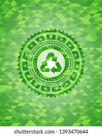 recycle icon inside green mosaic emblem