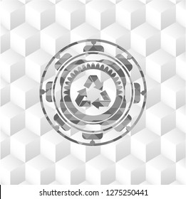 recycle icon inside grey badge with geometric cube white background