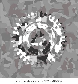 recycle icon inside grey camouflaged emblem